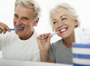 Senipr couple brushing their teeth