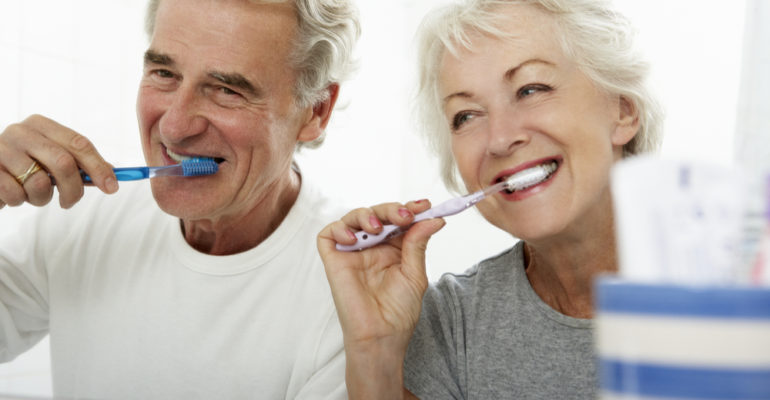Senipr couple brushing their teeth