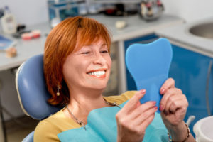 dental patient looking into a mirror dental veneers