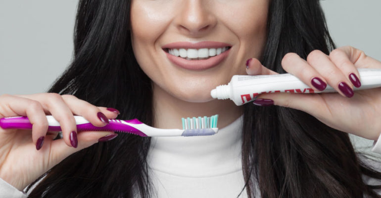 woman with toothbrush preventing gum disease