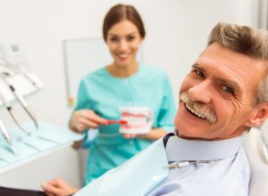 patient at dentist office | dental implants | replacing missing teeth