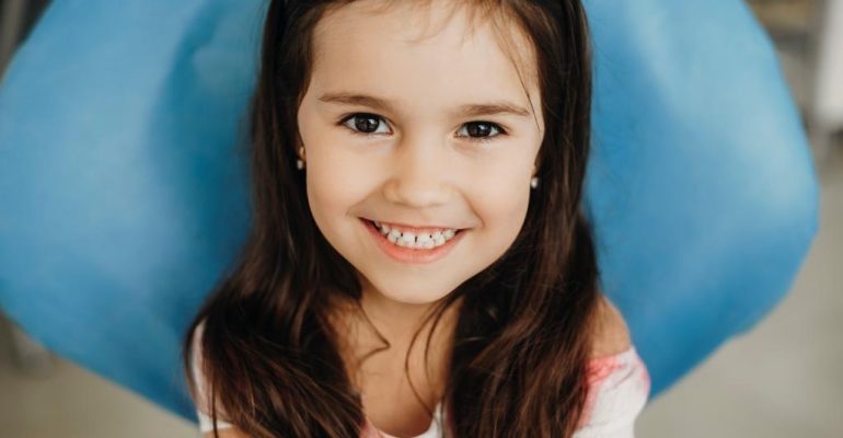 pediatric dentist | Little girl smiling at camera.