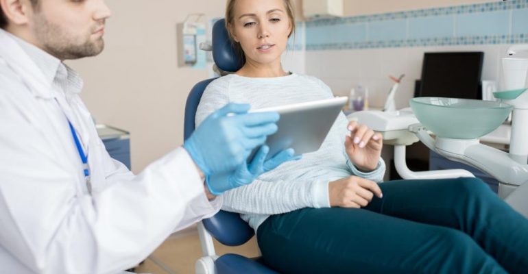 Gum Disease Treatment | Woman looking at tablet.
